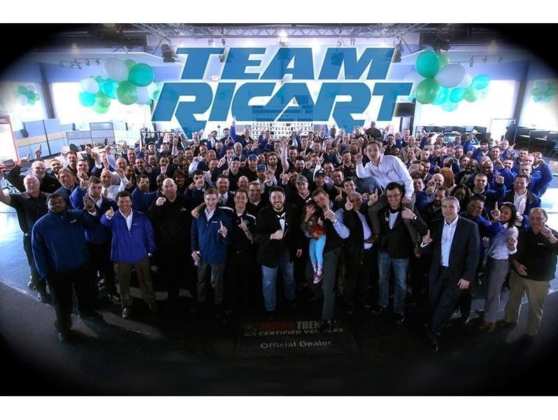 All the employee's of Ricart Hyundai raising their hands